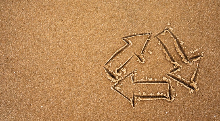 Recycle symbol on beach