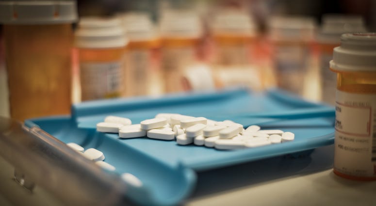 Unsorted prescription pills sit in a pharmacist's counting tray before they are bottled. Opioids (Getty)