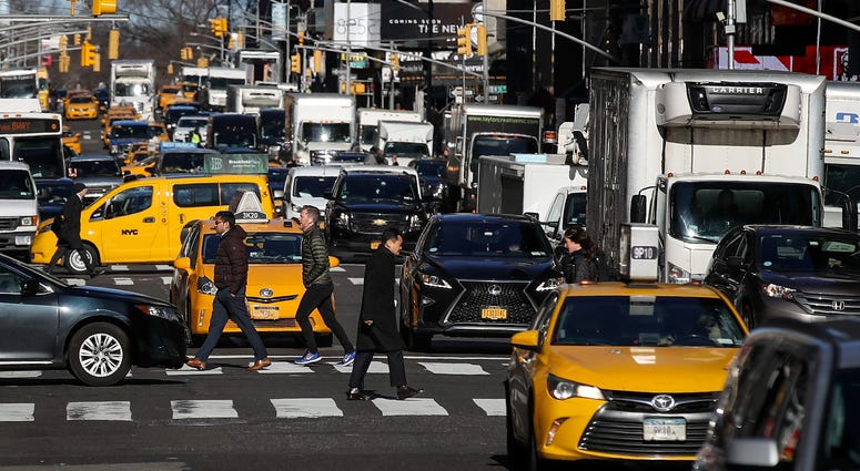 Traffic moves along 7th Avenue in Manhattan, January 25, 2018 in New York City. Manhattan traffic