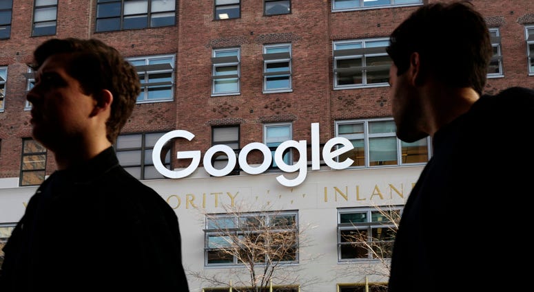 In this Dec. 4, 2017 file photo, people walk by Google offices in New York. Google