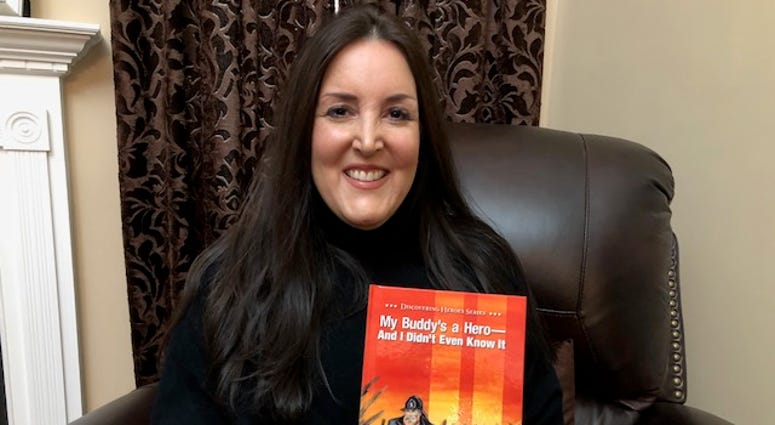 Kristie Kiernan Bouryal holds her book "My Buddy's a Hero And I Didn't Even Know It" Kristie Kiernan Bouryal