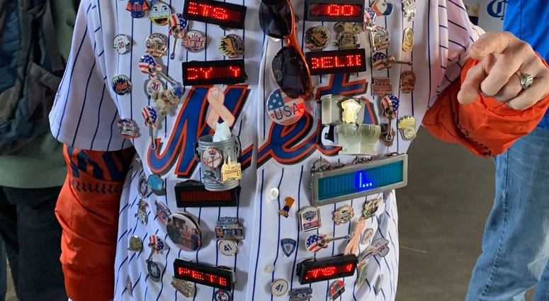 A fan arrives at Citi Field decked out in Mets gear. Citi Field Opening Day