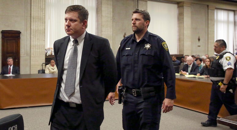 Chicago police Officer Jason Van Dyke, left, is taken into custody after jurors found him guilty of second-degree murder and aggravated battery in the 2014 shooting of black teenager Laquan McDonald, Friday, Oct. 5, 2018. Jason Van Dyke