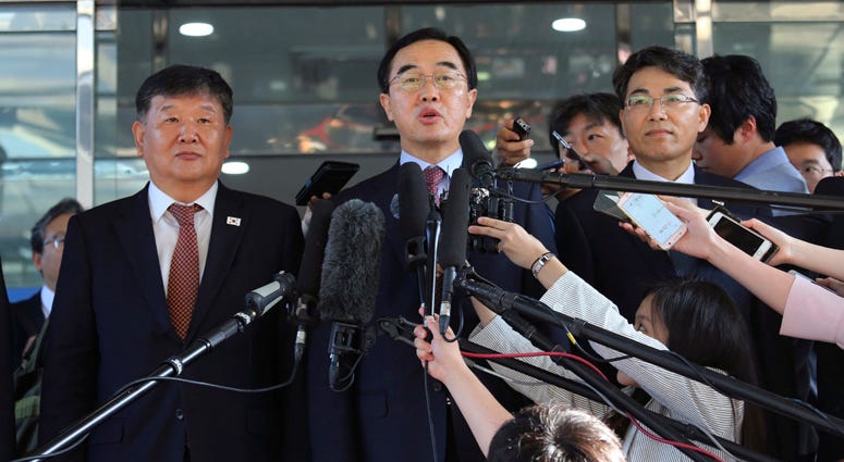 South Korean Unification Minister Cho Myoung-gyon, center, speaks to the media before leaving for the border village of Panmunjom to attend South and North Korean meeting, at the Office of the South Korea-North Korea Dialogue in Seoul, South Korea. South Korean Unification Minister