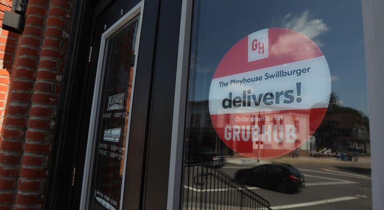 A large sign advertising Grubhub delivery for Playhouse/ Swillburger, greets visitors at the entrance to the restaurant, Thursday, Aug. 9, 2018. Grubhub Restaurant Sign