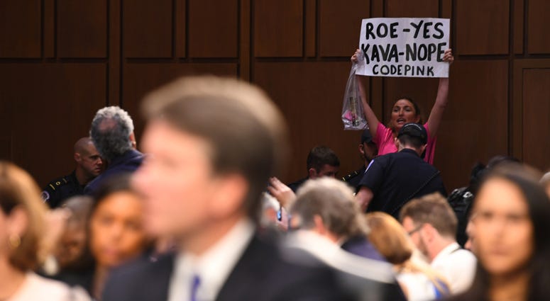 A protester interrupts the hearing for Supreme Court Associate Justice nominee Brett Kavanaugh before the Senate Judiciary Committee during his confirmation hearing. Brett Kavanaugh Hearing