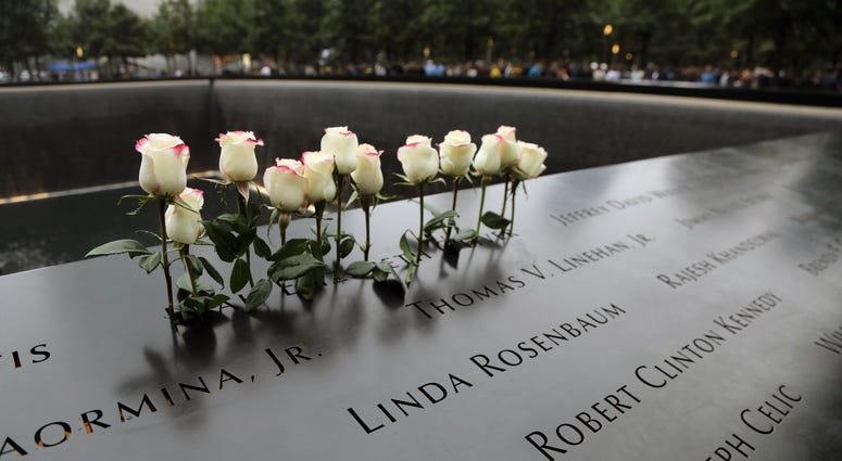 Flowers on the North Tower during ceremonies at the National September 11 Memorial observing the 17th anniversary of the attacks