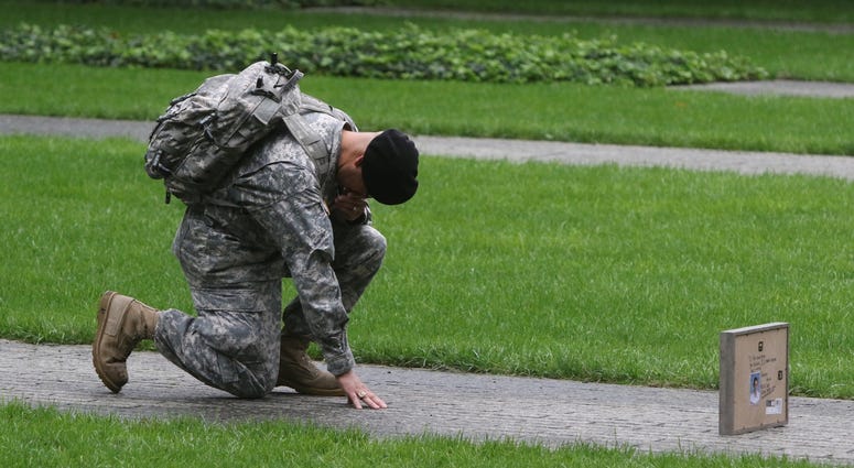 Army Sgt. Edwin Morales of the Bronx bows in honor for his cousin Ruben Correa