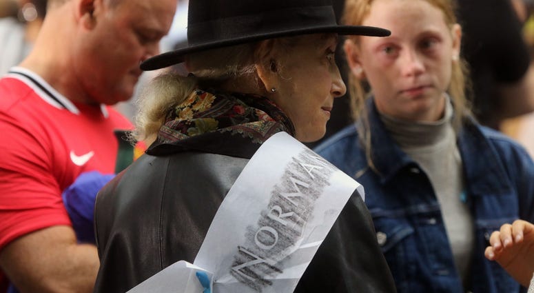 Ann Rossener with an etching for her son Norman who died on 9/11