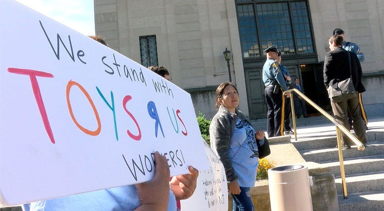 People protest outside the State Investment Council meeting at the War Memorial Thursday, September 27, 2108, where former Toys R Us employees testified. Toys R Us employees