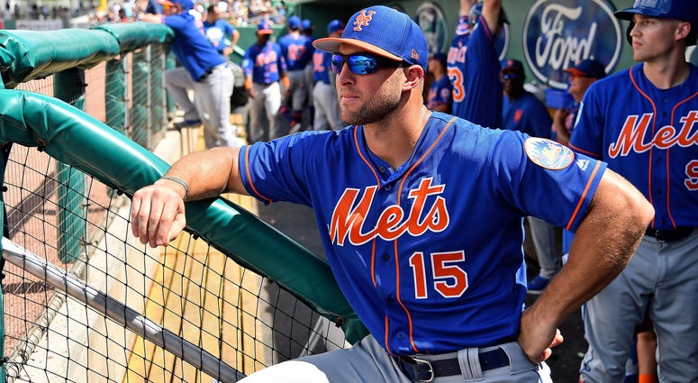 New York Mets left fielder Tim Tebow (15) looks on from the dugout priror to the spring training game against the Boston Red Sox at JetBlue Park. Tim Tebow