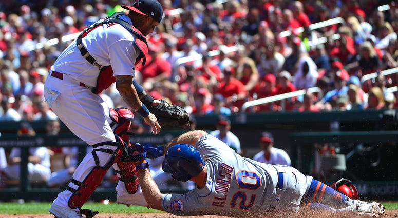 St. Louis Cardinals catcher Yadier Molina (4) tags out New York Mets first baseman Pete Alonso (20) during the third inning at Busch Stadium. Mets Cardinals