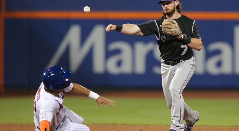 Colorado Rockies second baseman Brendan Rodgers (7) forces out New York Mets left fielder Dominic Smith (22) then throws to first rot complete a double play on a ball hit by New York Mets catcher Wilson Ramos (not pictured) during the sixth inning at Citi Mets Rockies
