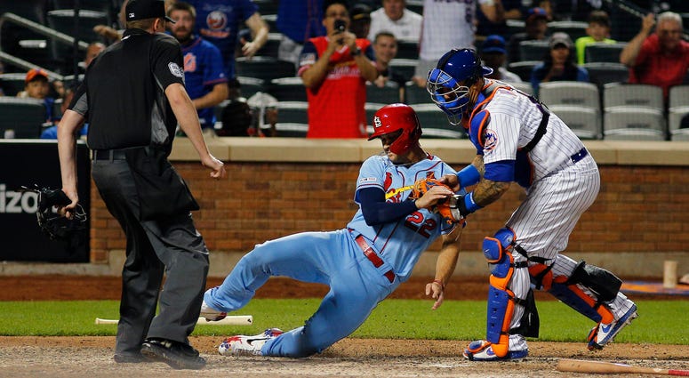 St. Louis Cardinals pinch runner Jack Flaherty (22) is tagged out at home plate by New York Mets catcher Wilson Ramos (40) attempting to score on a base hit during the ninth inning at Citi Field. Mets Cardinals