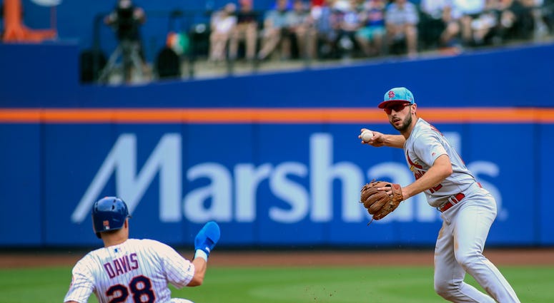 St. Louis Cardinals shortstop Paul DeJong (12) tries to turn a double play against New York Mets third baseman J.D. Davis (28) in the first inning at Citi Field. Cardinals Mets