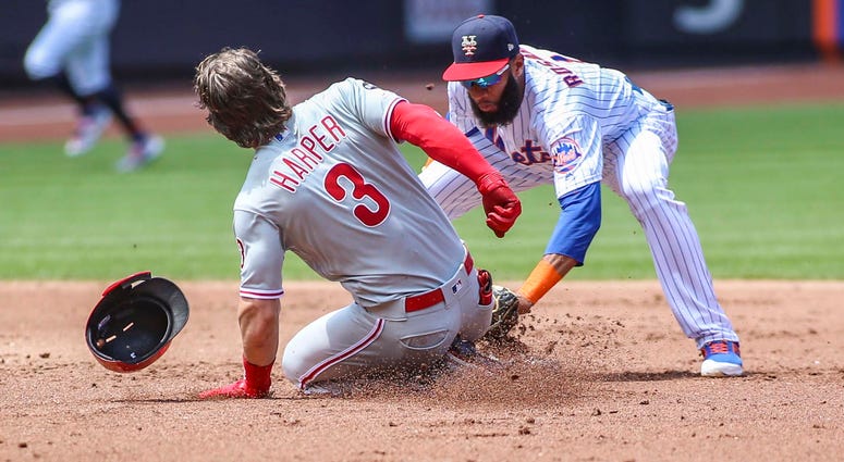 Philadelphia Phillies right fielder Bryce Harper (3) is tagged out at second base by New York Mets shortstop Amed Rosario (1) in the second inning at Citi Field. Mets Phillies