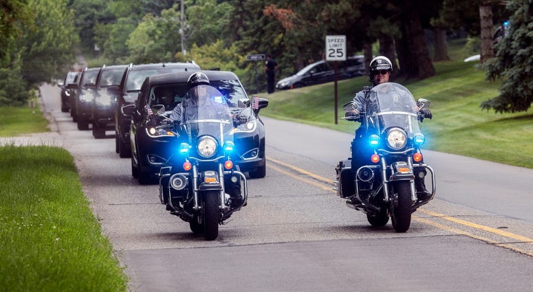 Police escort the funeral procession along Opdyke Road following services for automobile executive Lee Iacocca at St. Hugo of the Hills in Bloomfield Hills, Mich., Wednesday, July 10, 2019. Police escort funeral procession