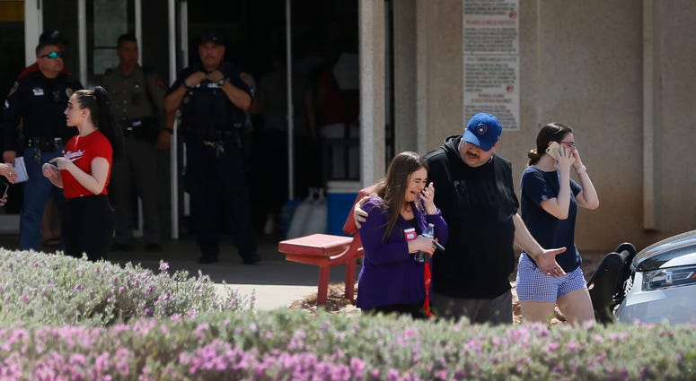 People arrive at MacArthur Elementary looking for family and friends as the school is being used a re-unification center during the aftermath of a shooting at the Walmart in the Cielo Vista Mall area Saturday, Aug. 3, 2019 in El Paso, Texas. El Paso shooting