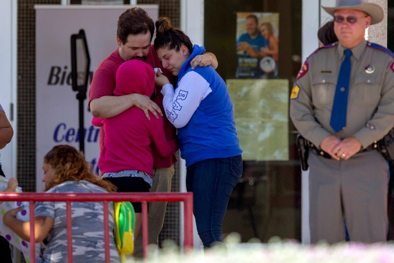 Loved ones comfort each other outside of MacArthur School Elementary-Intermediate School on August 4, 2019, in El Paso, Texas. El Paso shooting
