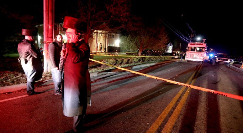 Hasidic Jewish men stand outside the home of a rabbi on Forshay Rd. in Monsey, N.Y. Monsey Stabbing