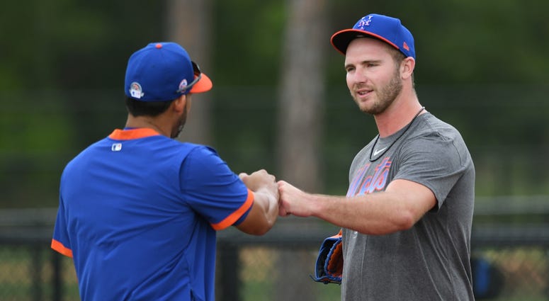 New York Mets first baseman Pete Alonso (right) greets coach Luis Rivera during a workout at spring training. Pete Alonso