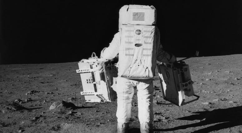 Buzz Aldrin Edwin 'Buzz' Aldrin Jr. prepares to deploy part of the Early Apollo Scientific Experiments Package on NASA's Apollo 11 lunar landing mission.