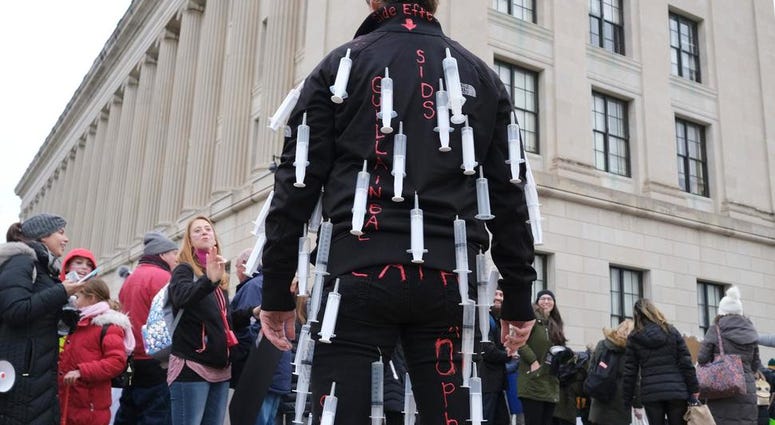 Melissa Koscielniak wears syringes all over her body during a protest at the state house in Trenton, N.J., Monday, Jan. 13, 2020. Vaccine Protest (AP)