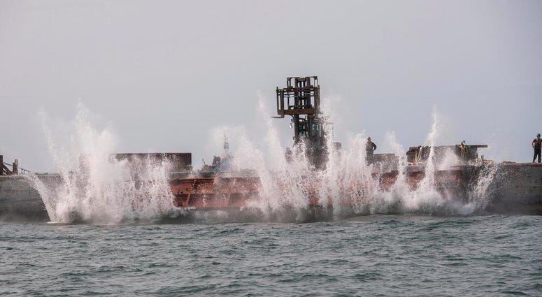 In this photo provided the Office of Governor Andrew M. Cuomo, an old rail car is dumped into the ocean a few miles off shore from Point Lookout, N.Y., Wednesday, Sept. 16, 2020. old rail car is dumped into the ocean