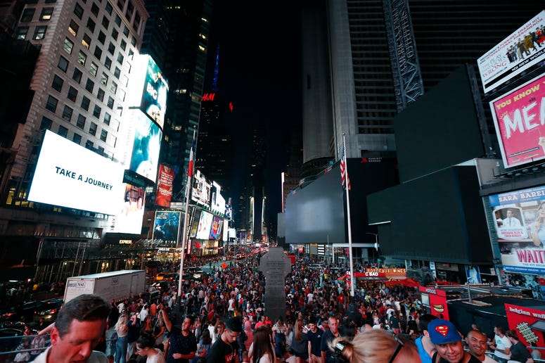 Screens in Times Square are black during a widespread power outage, Saturday, July 13, 2019, in the Manhattan borough of New York. NYC power outage