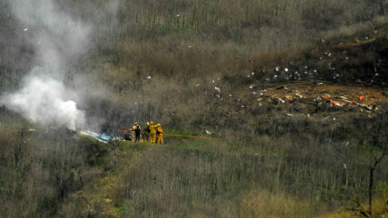 Firefighters work the scene of a helicopter crash where former NBA star Kobe Bryant died, Sunday, Jan. 26, 2020, in Calabasas, Calif. Kobe Bryant crash
