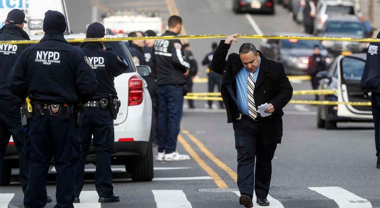 New York City police officers work the scene of a police involved shooting outside the 41st precinct Sunday, Feb. 9, 2020, in New York. NYPD officers shot
