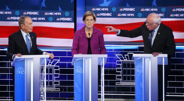 Sen. Bernie Sanders (I-VT) (R) gestures as Sen. Elizabeth Warren (D-MA) and former New York City mayor Mike Bloomberg listen during the Democratic presidential primary debate at Paris Las Vegas on February 19, 2020 in Las Vegas, Nevada. Mike Bloomberg, Elizabeth Warren and Bernie Sanders