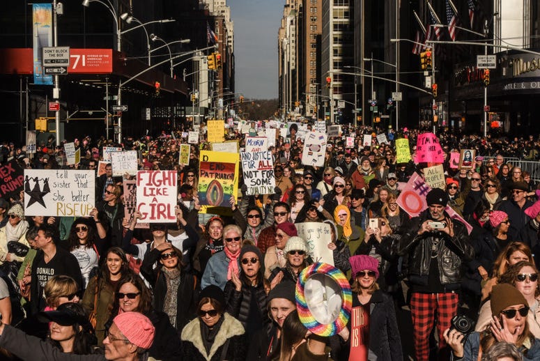 A large crowd of people participating in the Women's March makes its way down 6th Avenue in Manhattan on January 20, 2018 in New York City. Women's March