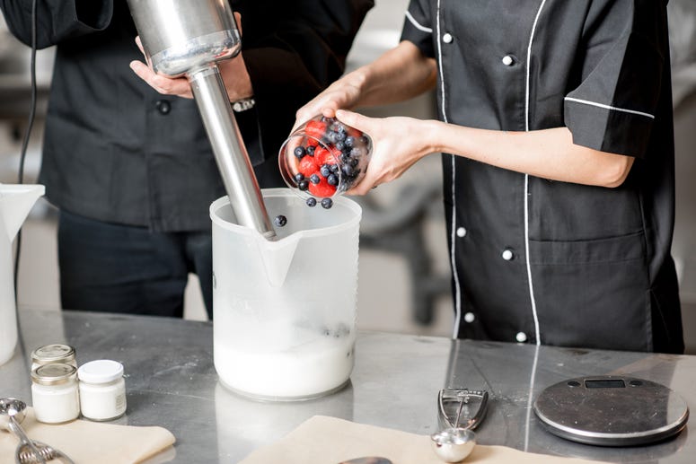 Mixing berries with milk and sugar with professional blender for ice cream production Ice Cream Making Class
