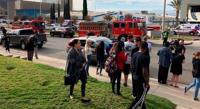 People wait for students and updates outside of Saugus High School after reports of a shooting on Thursday, Nov. 14, 2019, in Santa Clarita, Calif. Southern California Shooting