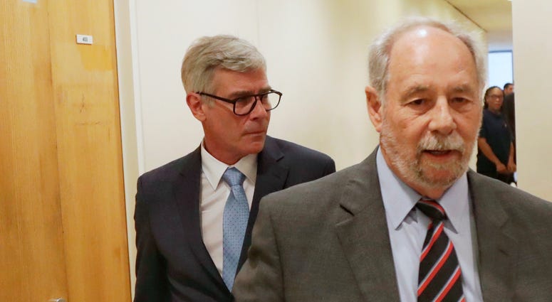 In this April 17, 2019, photo, Timothy Williams, walking behind his attorney Philip Scardino, leaves Harris County Criminal Court at Law No. 9 in Houston, Texas Trivago Guy in court