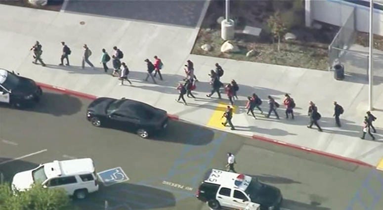 People are lead out of Saugus High School after reports of a shooting on Thursday, Nov. 14, 2019 in Santa Clarita, Calif. Southern California Shooting