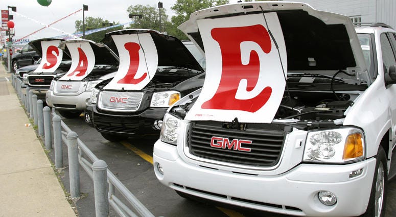 Sale signs lie on vehicles at a General Motors Chevrolet dealership July 6, 2005 in Ferndale, Michigan. Car dealership