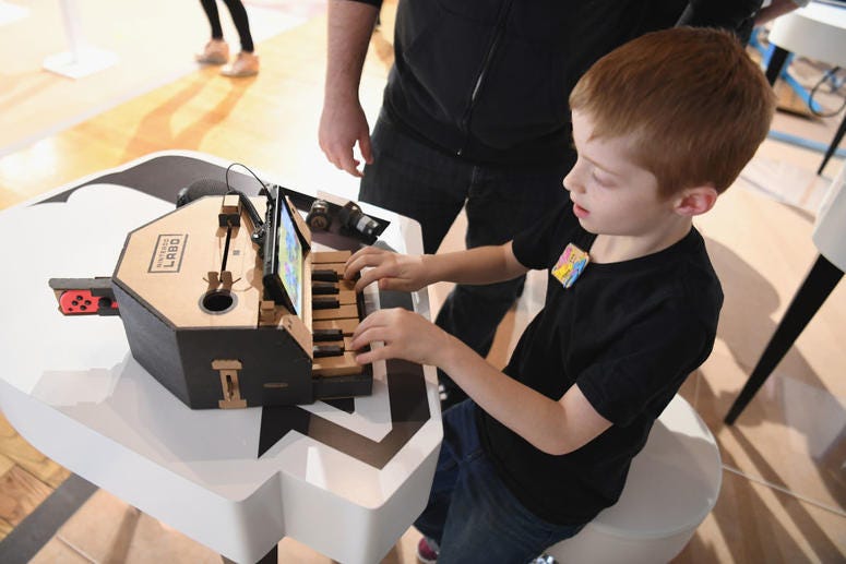 In this photo provided by Nintendo of America, kids enjoy playing tunes on a Toy-Con Piano at an exclusive event in New York on Feb. 2, 2018. Toy Convention