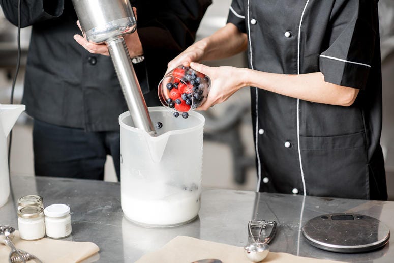Mixing berries with milk and sugar with professional blender for ice cream production Ice Cream Making Class