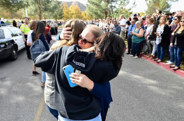 A parent is reunited with her children after a student was killed and other injured during a shooting at Saugus High School in Santa Clarita, Calif. on Nov. 14, 2019. Southern California Shooting