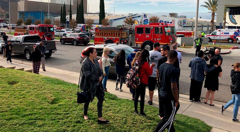 People wait for students and updates outside of Saugus High School after reports of a shooting on Thursday, Nov. 14, 2019, in Santa Clarita, Calif. Southern California Shooting