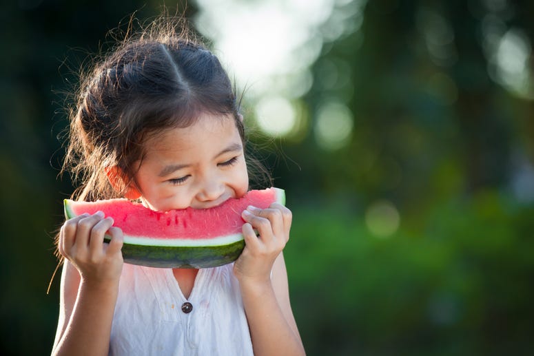 Little girl eating a watermelon. Little girl eating a watermelon.