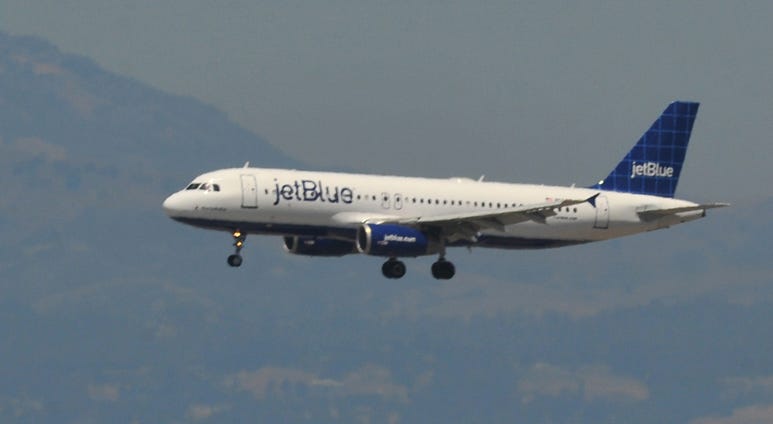 A JetBlue plane lands at San Francisco International Airport. JetBlue Plane