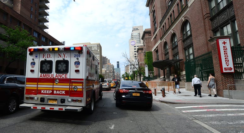 An FDNY ambulance drives past the Bellevue Hospital emergency room ambulance driveway in New York, NY, on June 25, 2015. FDNY ambulance