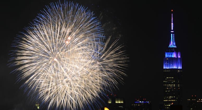 Fireworks explode over the East River with the Empire State Building in the background during the 39th Annual Macy's Fourth of July fireworks display celebrating America's 239th Independence Day, as seen from the New York borough of Queens, NY on July 4. Empire State Building fireworks
