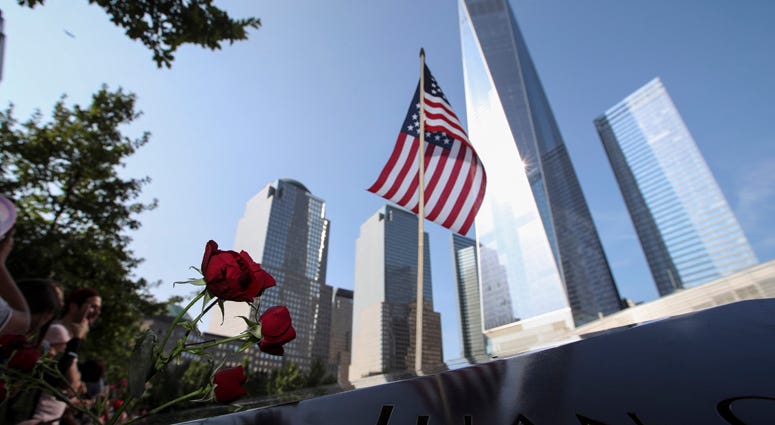 Flowers and a U.S. flag are placed on a plate on which the names of 9/11 victims were inscribed around the South Pool at the National September 11 Memorial and Museum. 9/1 Memorial, World Trade Center