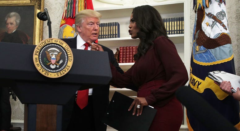 FILE -- U.S. President Donald Trump listens to Director of Communications for the White House Public Liaison Office Omarosa Manigault during an event in the Oval Office of the White House on October 24, 2017 Donald Trump, Omarosa
