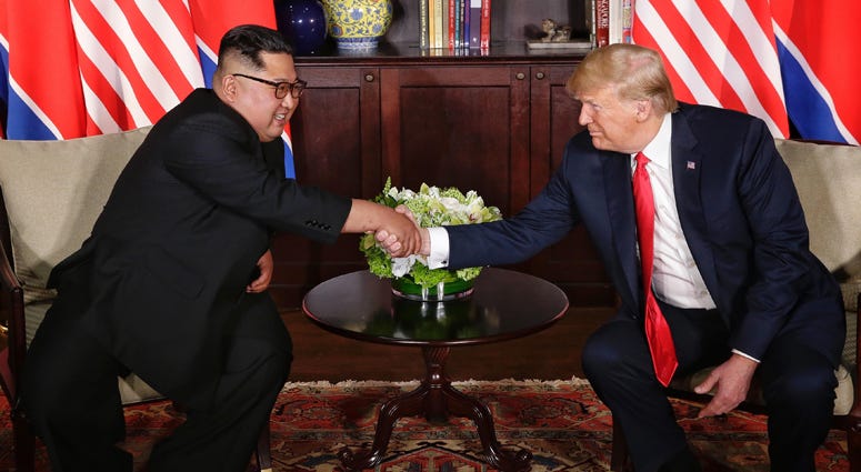 Top leader of the Democratic People's Republic of Korea (DPRK) Kim Jong Un (L) meets with U.S. President Donald Trump in Singapore, on June 12, 2018. Donald Trump, Kim Jong Un