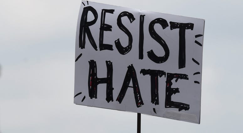 A protester holds a poster at the freedom plaza near the White House in Washington D.C., the United States, on Aug. 12, 2018. ANTI WHITE SUPREMACIST